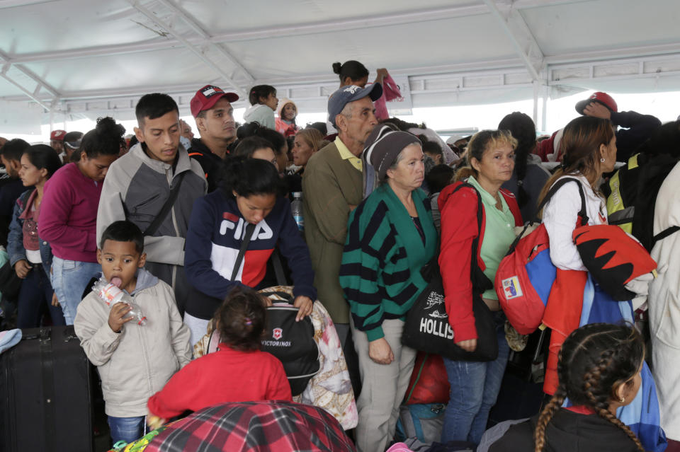 Venezuelans line up at an immigration processing office on the Rumichaca bridge, before crossing the border from Colombia to Ecuador, Thursday, June 13, 2019. Venezuelan migrants are making their way to Peru, where on June 15, the country will start requiring them to have a passport and a humanitarian visa. (AP Photo/Dolores Ochoa)