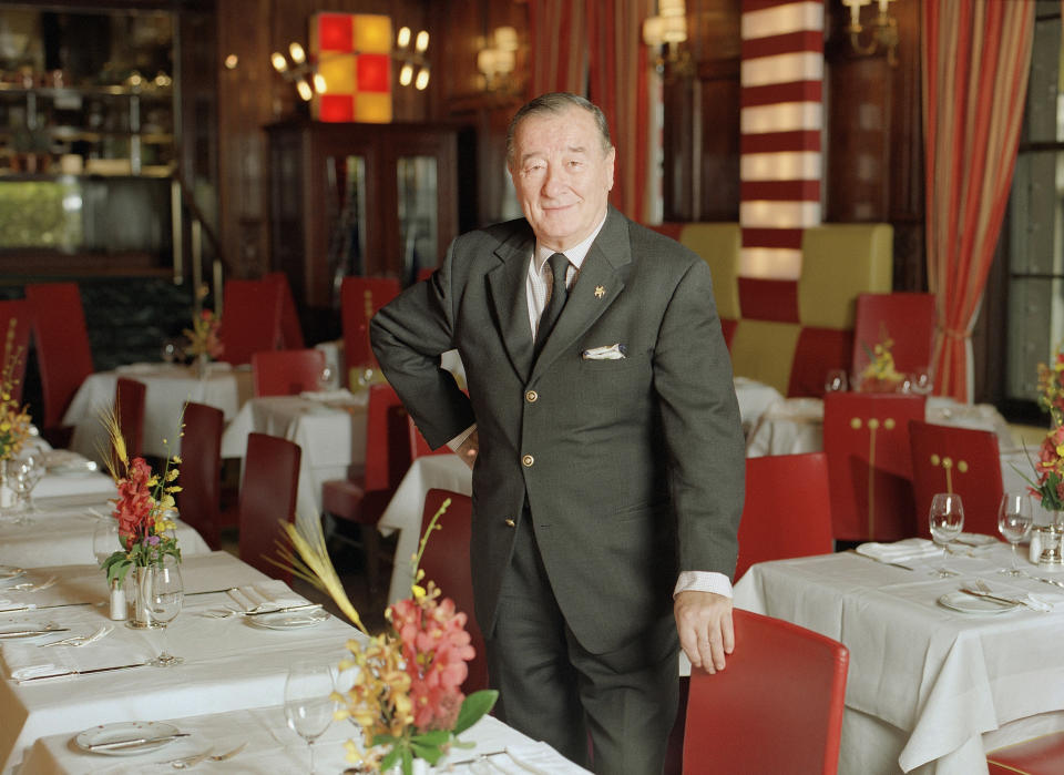 FILE - This Nov. 12, 1999 file photo shows restaurateur Sirio Maccioni, owner of Le Cirque 2000, standing inside the celebrated French restaurant in New York. Maccioni, who opened the celebrated French restaurant Le Cirque in New York and watched it grow into arguably Manhattan’s favorite dining room of the rich and famous, has died in Italy. He was 88. Maccioni's son, Mauro, told The Associated Press that his father died in the family's villa in Tuscany early Monday, April 20, 2020. He had suffered from the effects of a stroke and Alzheimer’s disease, the son said. (AP Photo/Jim Cooper, File)