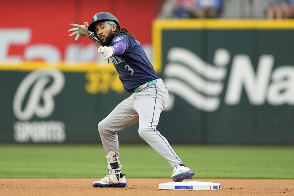 Seattle Mariners' J.P. Crawford celebrates after hitting for a double in the first inning of a baseball game against the Texas Rangers in Arlington, Texas, Tuesday, April 23, 2024. (AP Photo/Tony Gutierrez)