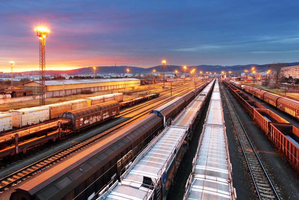 A contemporary train yard at dusk.