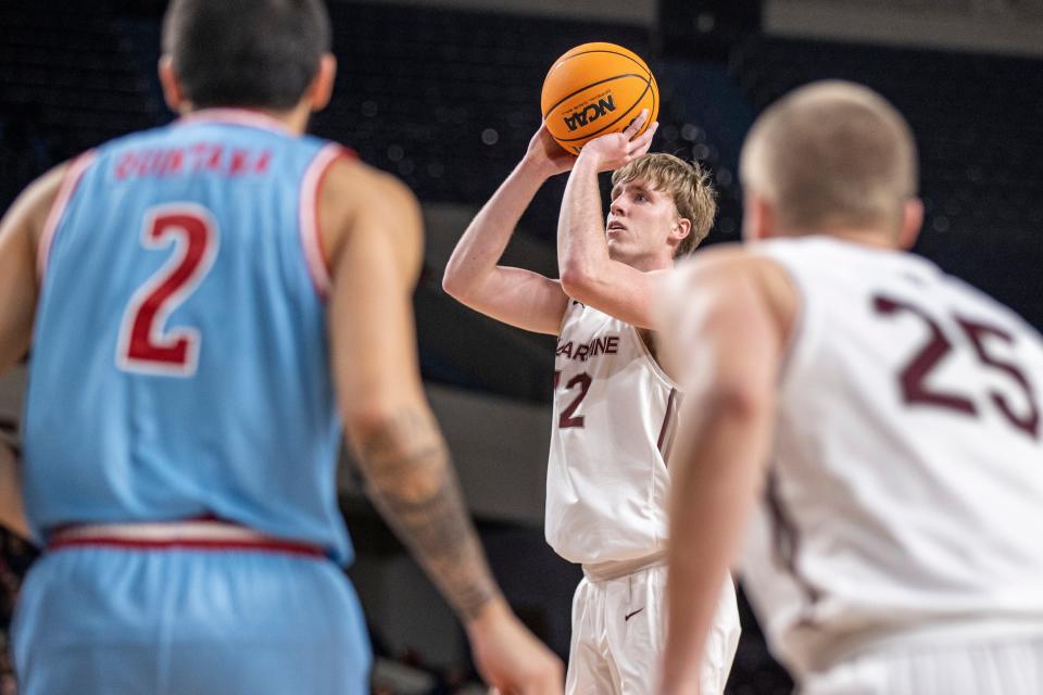 Bellarmine's Curt Hopf, center, shoots a three-pointer during the second half as the Knights took on Loyola Marymount University at Freedom Hall on Tuesday night. Dec. 21, 2021
