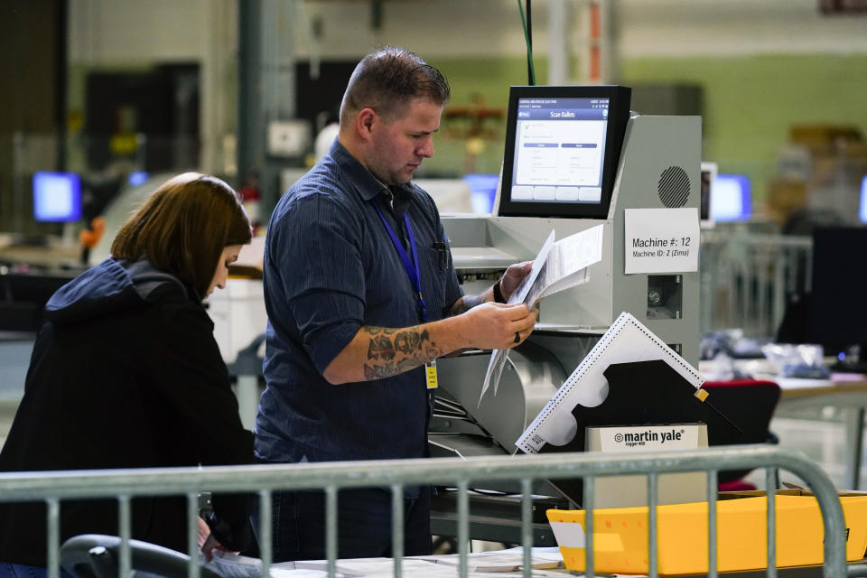 Election workers process mail-in-ballots for the midterm elections in Philadelphia, Tuesday, Nov. 8, 2022. (AP Photo/Matt Rourke)