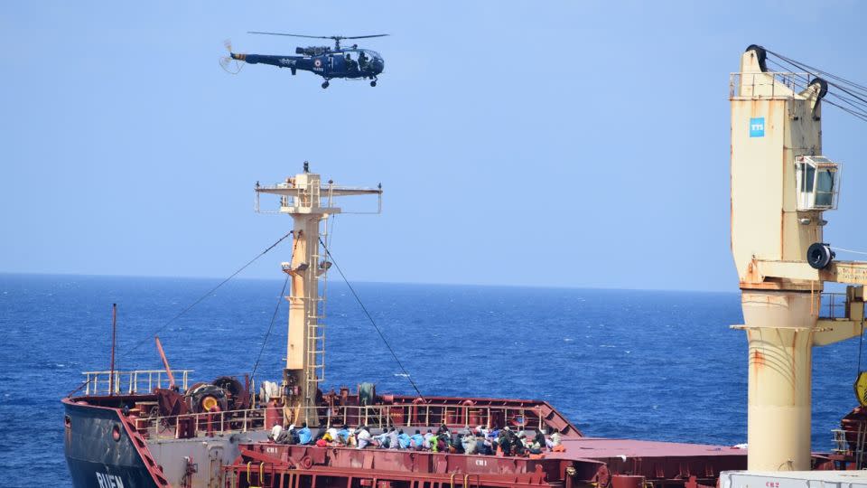 A helicopter flies over the commercial vessel MV Ruen during an Indian military anti-piracy operation last weekend. - Ministry of Defence/PIB