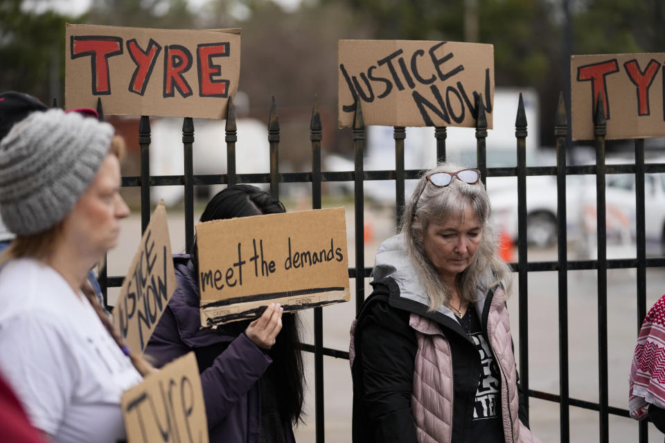 A group of demonstrators protest outside a police precinct in response to the death of Tyre Nichols, who died after being beaten by Memphis police officers, in Memphis, Tenn., Sunday, Jan. 29, 2023. (AP Photo/Gerald Herbert)