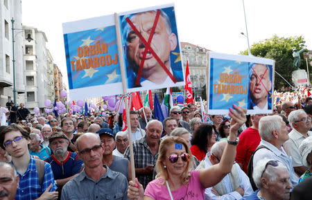 People attend a demonstration against Hungary's Prime Minister Viktor Orban in Budapest, Hungary, September 16, 2018. The placard reads: "Orban step down". REUTERS/Bernadett Szabo