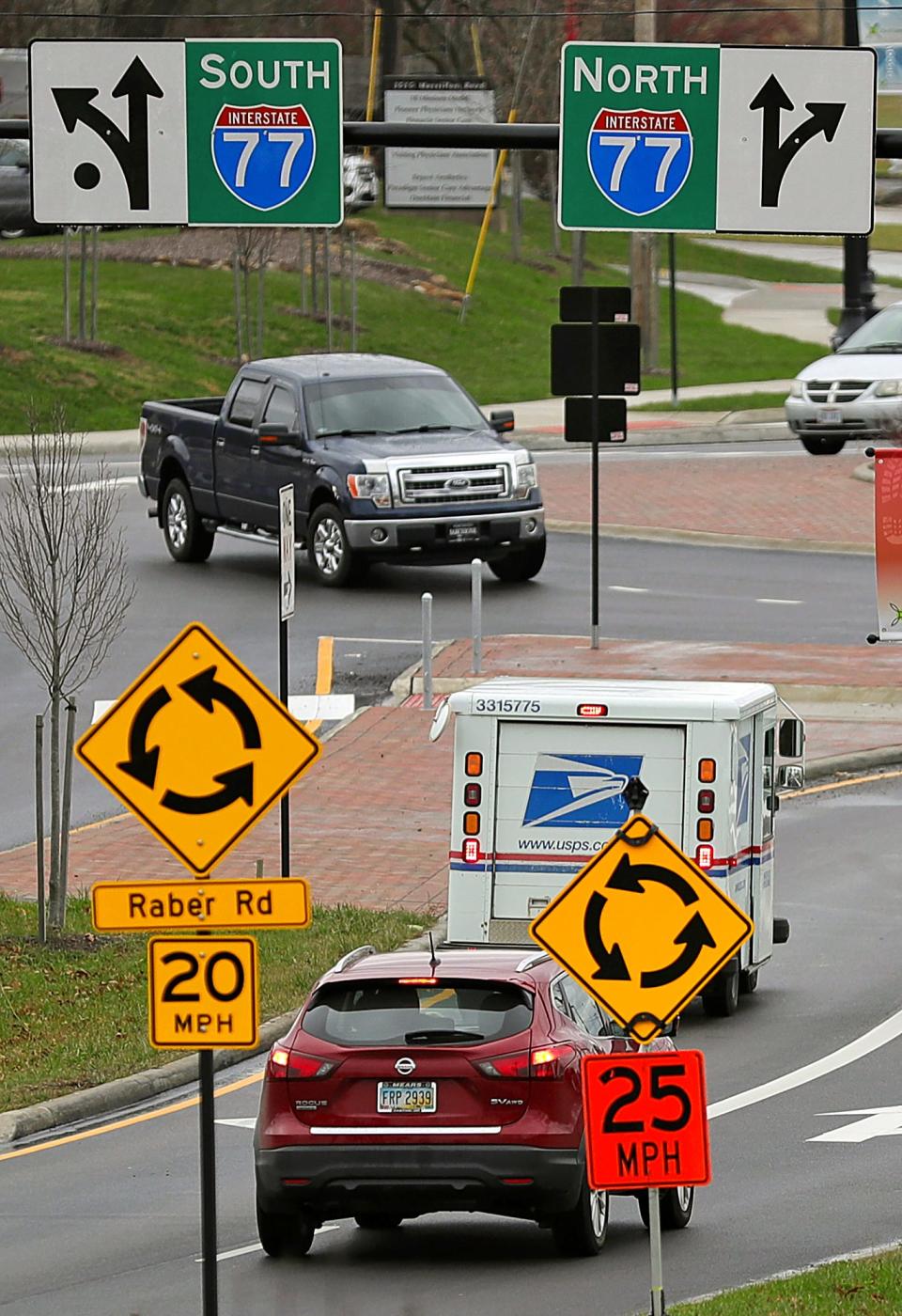 Motorists navigate the roundabout at the intersection of Massillon and Raber roads Dec. 15 in Green.