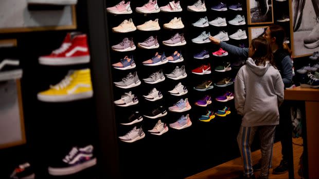 A mother and daughter shop for sneakers in a Dick's Sporting Goods