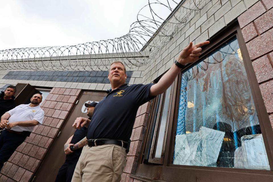 Bristol County Sheriff Paul Heroux speaks in front of the unit at the Dartmouth House of Correction damaged by inmates in this May 3, 2023 file photo. The window behind him was shattered by inmates.