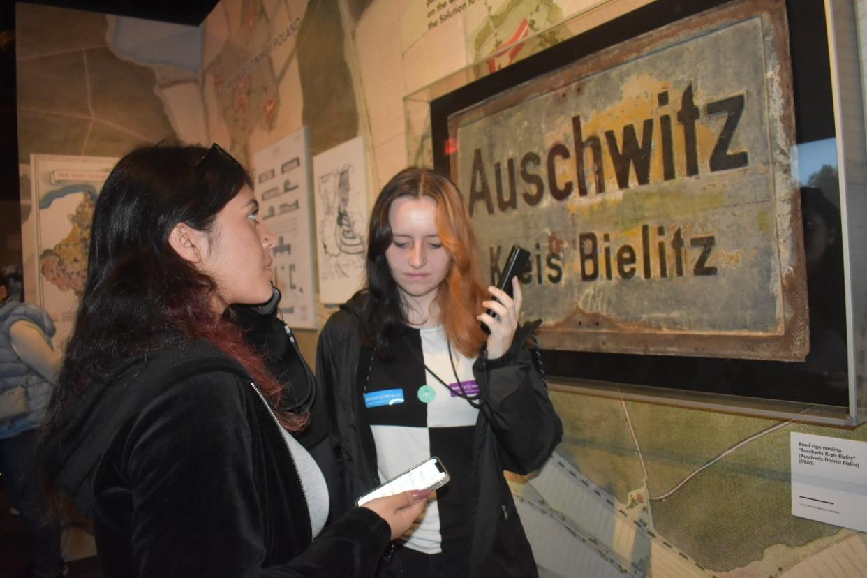 Jaynalynn Villarreal, left, and Mattylin Wilson, both of Monte Vista School in Simi Valley listen to audio tours at an Auschwitz exhibit at the Ronald Reagan Presidential Library in April. The exhibit has been extended into January.