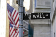 FILE - Flags adorn the facade of the New York Stock Exchange, Wednesday, June 16, 2021. Wall Street is retreating a bit more as a five-week rally loses momentum. The S&P 500 was 0.4% lower in early trading Wednesday, June 21, 2023.(AP Photo/Richard Drew, File)