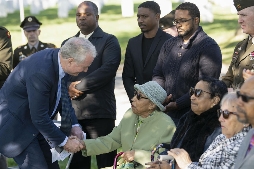 FILE - Sen. Chris Van Hollen, D-Md., left, shakes hands with Joann Woodson, the widow of Cpl. Waverly B. Woodson Jr., during a medal ceremony posthumously honoring Cpl. Woodson with the Bronze Star and Combat Medic Badge at Arlington National Cemetery, Oct. 11, 2023 in Arlington, Va. Woodson Jr., a medic who was part of the only Black combat unit to take part in the D-Day invasion of France, is being posthumously awarded the Distinguished Service Cross. It's the military's second highest honor. The announcement was made Monday, June 3, 2024, by Van Hollen. (AP Photo/Kevin Wolf, File)