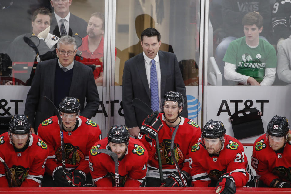 Chicago Blackhawks coach Jeremy Colliton, center, yells to his team during the third period of an NHL hockey game against the Anaheim Ducks on Saturday, Jan. 11, 2020, in Chicago. (AP Photo/Kamil Krzaczynski)