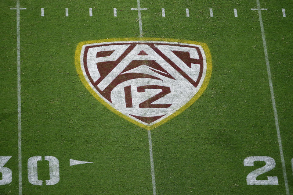 FILE - This Aug. 29, 2019, file photo shows the Pac-12 logo at Sun Devil Stadium during the second half of an NCAA college football game between Arizona State and Kent State in Tempe, Ariz. The Pac-12 has become the second major conference to shift to a conference-only fall schedule amid growing concerns over the coronavirus pandemic. (AP Photo/Ralph Freso, File)