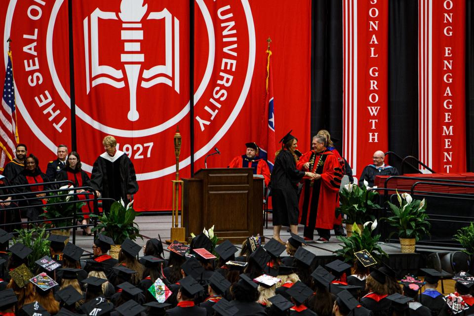 President Michael Licari hands out degrees to students graduating during the 2023 Austin Peay University commencement ceremony at the Dunn Center in Clarksville, Tenn. on May. 5, 2023. 