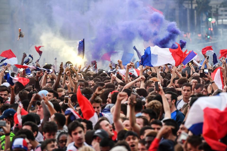 <p>People celebrate France’s victory at a fan zone in central Paris on July 10, 2018 at the final whistle of the Russia 2018 World Cup semi-final football match between France and Belgium. (Photo by Eric FEFERBERG / AFP) </p>