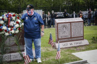 A motorcade of veterans stops outside the VA Medical Center as wreaths are laid beside memorial stones on the premises, Monday, May 25, 2020, in the Brooklyn borough of New York. (AP Photo/John Minchillo)