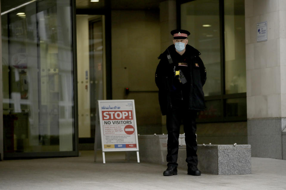 A police officer stands guard outside the main entrance of St Bartholomew's Hospital in London, where Britain's Prince Philip is being treated, Wednesday, March 3, 2021. Buckingham Palace said Philip, the 99-year-old husband of Queen Elizabeth II, was transferred from King Edward VII's Hospital to St Bartholomew's Hospital on Monday to undergo testing and observation for a pre-existing heart condition as he continues treatment for an unspecified infection. (AP Photo/Matt Dunham)