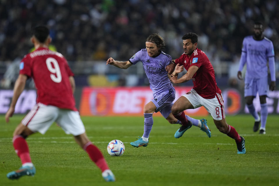 Real Madrid's Luka Modric, center left, duels for the ball with Al Ahly's Hamdy Fathy during the FIFA Club World Cup semi final match between Al Ahly and Real Madrid at Prince Moulay Abdellah stadium in Rabat, Morocco, Wednesday, Feb. 8, 2023. (AP Photo/Manu Fernandez)