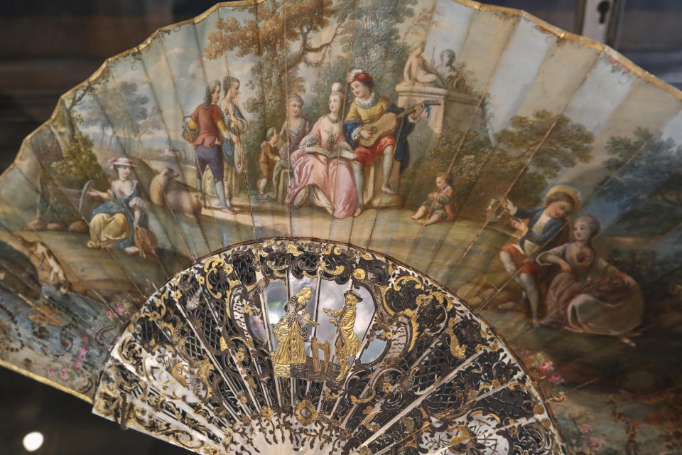 A hand fan representing a musical relaxing moment (detente musicale) is pictured at the hand fan-making museum in Paris, Wednesday, Jan. 20, 2021. Just like the leaves of its gilded fans, France's storied hand fan-making museum could fold up and vanish. The splendid Musee de l'Eventail in Paris, a classed historical monument, is the culture world's latest coronavirus victim. (AP Photo/Michel Euler)