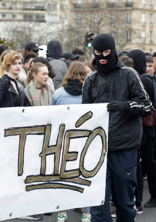 French protesters hold a banner reading "Theo" during a student rally against police brutality in Paris, on February 23, 2017