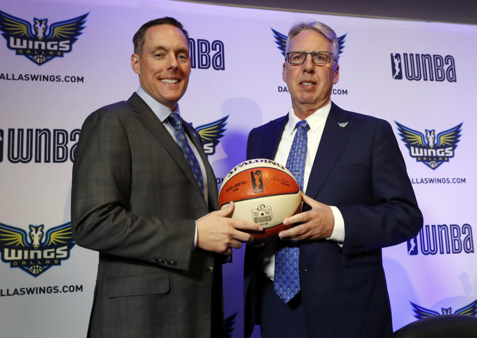 Dallas Wings President and CEO Greg Bibb, left, poses for a photo with newly hired head coach Brian Agler, right, after a news conference where Agler was officially introduced, Tuesday, Dec. 18, 2018, in Arlington, Texas. (AP Photo/Tony Gutierrez)