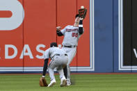 Minnesota Twins' Brent Rooker (50) catches a fly ball off the bat of Toronto Blue Jays' George Springer over a ducking Nick Gordon in the fifth inning of a baseball game in Toronto on Saturday, Sept. 18, 2021. (Jon Blacker/The Canadian Press via AP)