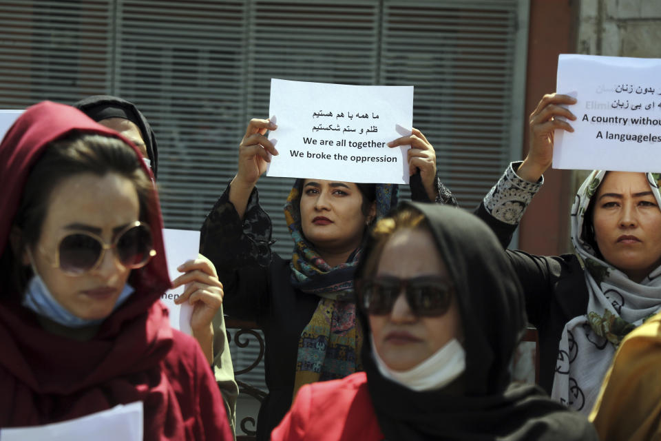 Women gather to demand their rights under the Taliban rule during a protest in Kabul, Afghanistan, Friday, Sept. 3, 2021. As the world watches intently for clues on how the Taliban will govern, their treatment of the media will be a key indicator, along with their policies toward women. When they ruled Afghanistan between 1996-2001, they enforced a harsh interpretation of Islam, barring girls and women from schools and public life, and brutally suppressing dissent. (AP Photo/Wali Sabawoon)