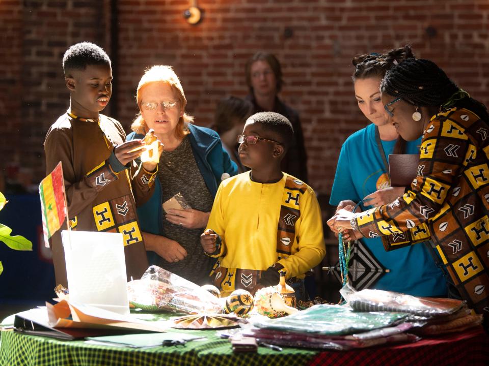 Brothers Abdul and Elhaj Kone sell clothing, jewelry, and decorative items they brought from their travels to Senegal for the Acton Children's Business Fair at the Mill & Mine on March 5.