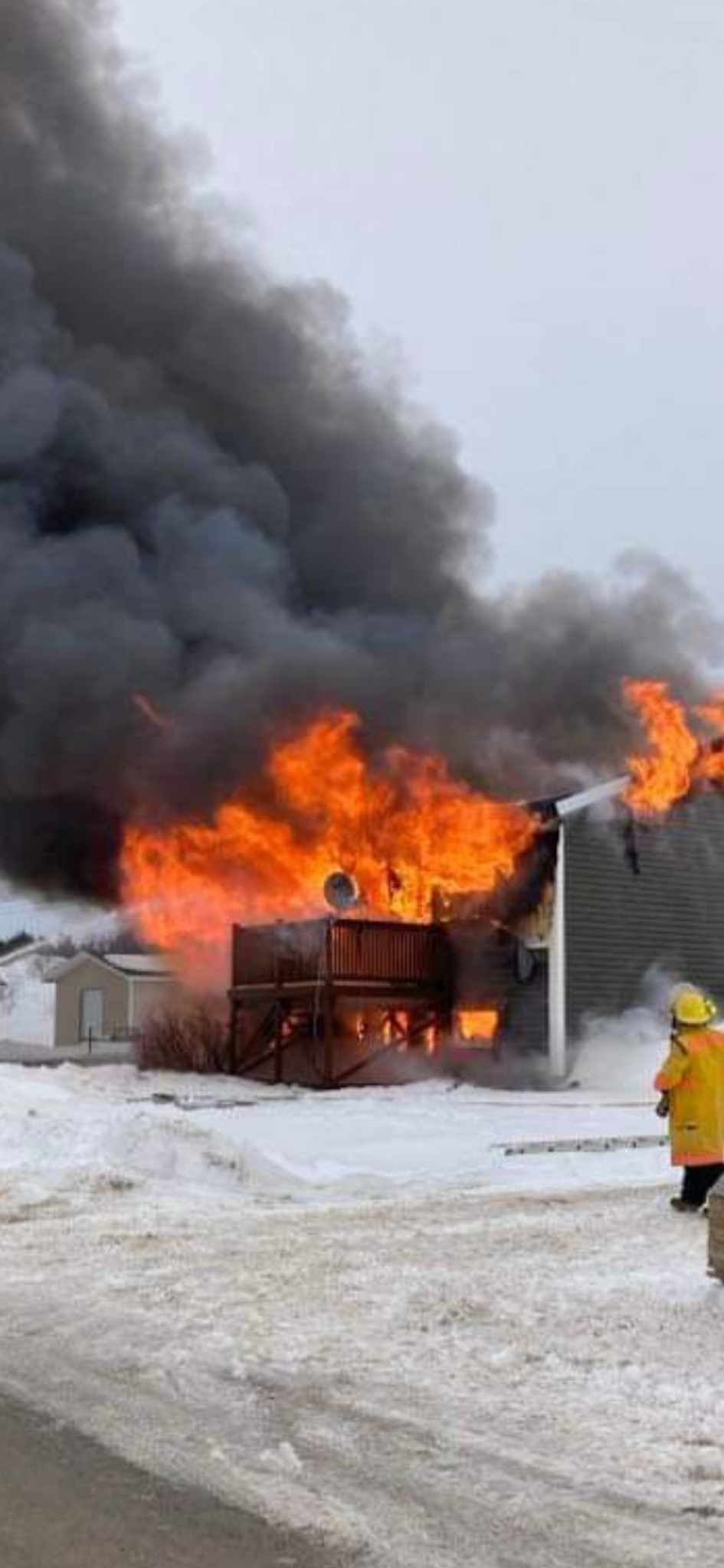 By the time fire fighters arrived on scene, the house was completely engulfed in flames.  (Submitted by Gerard Clements - image credit)