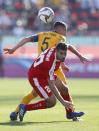 Palestine's midfielder Nazmi Albadawi and Australia's midfielder Mark Milligan, top, vie for the ball during the AFC Asian Cup group B soccer match between Australia and Palestine at Al Maktoum Stadium in Dubai, United Arab Emirates, Friday, Jan. 11, 2019. (AP Photo/Hassan Ammar)