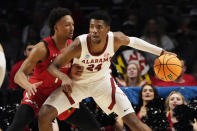 Alabama forward Brandon Miller (24) is guarded by Maryland guard Jahmir Young (1) in the first half of a second-round college basketball game in the NCAA Tournament in Birmingham, Ala., Saturday, March 18, 2023. (AP Photo/Rogelio V. Solis)