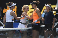 Barbora Krejcikova, left, and Katerina Siniakova of the Czech Republic are congratulated by Anna Danilina, right, of Kazakhstan and Beatriz Haddad Maia of Brazil after their win in the women's doubles final at the Australian Open tennis championships in Sunday, Jan. 30, 2022, in Melbourne, Australia.(AP Photo/Andy Brownbill)
