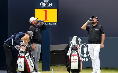 Republic Of Ireland's Shane Lowry and USA's JB Holmes have drinks on the 1st tee during day three of The Open Championship 2019 at Royal Portrush Golf Club - Credit: PA