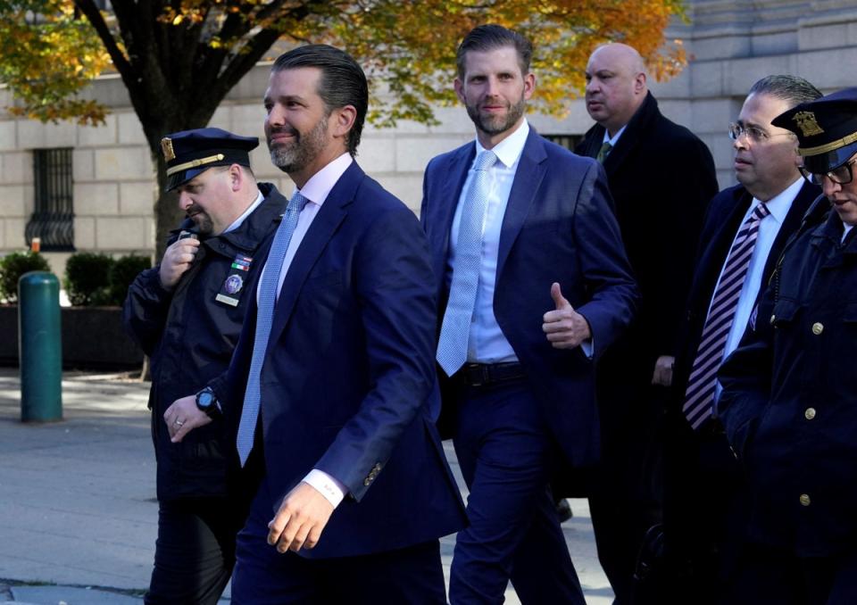 Donald Trump Jr and Eric Trump walk to the New York State Supreme Court building in Manhattan on 2 November for testimony in a civil fraud trial targeting the family’s business (AFP via Getty Images)