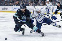 Seattle Kraken forward Matty Beniers, left, skates against Tampa Bay Lightning forward Alex Killorn during the first period of an NHL hockey game Monday, Jan. 16, 2023, in Seattle. (AP Photo/Stephen Brashear)