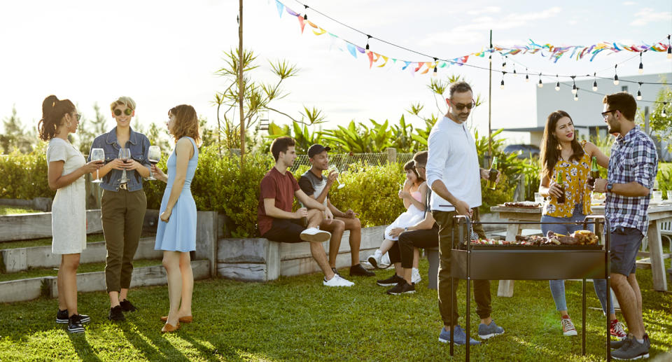 PEOPLE GATHERED OUTSIDE TO BBQ