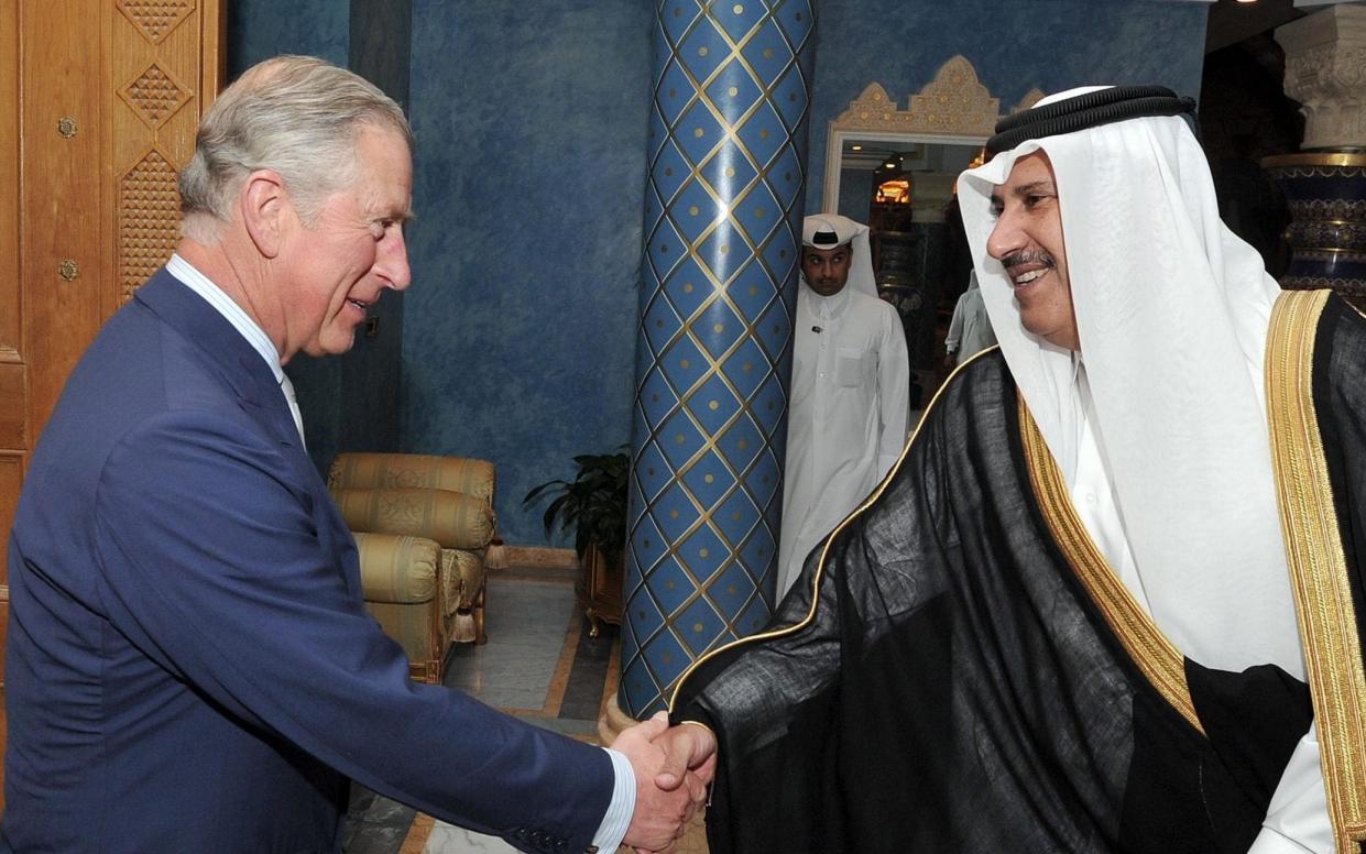 The Prince of Wales shakes hands with Sheikh Hamad Bin Jassim al Thani in Qatar in 2013 - John Stillwell/PA