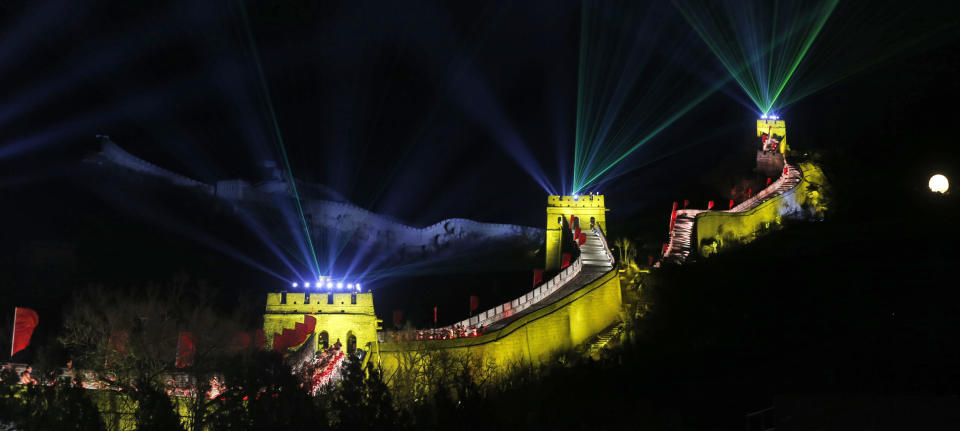 Laser lights shoot from towers during a New Year's Eve count down to 2014 held at the Great Wall of China in Beijing, China, Tuesday, Dec. 31, 2013. (AP Photo/Ng Han Guan)