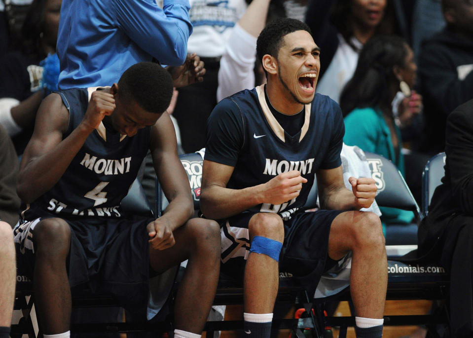 Mount St. Mary's' Khalid Nwandu (4) and Julian Norfleet (23) celebrate on the bench during the second half of the Northeastern Conference championship NCAA college basketball game against Robert Morris on Tuesday, March 11, 2014, in Coraopolis, PA. Mt. Saint Mary won 88-71.(AP Photo/Don Wright)
