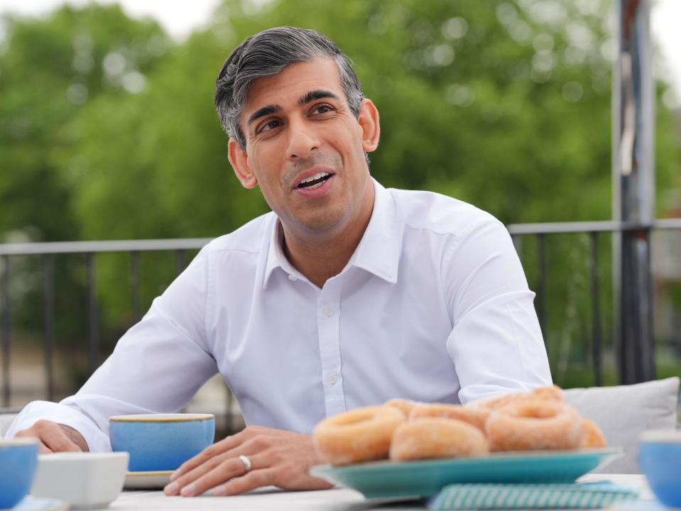 Prime Minister Rishi Sunak speaks to rowing club members with during a visit to the Leander Club in Henley-on-Thames, Oxfordshire, in Oxfordshire, while on the General Election campaign trail. Picture date: Monday June 3, 2024.