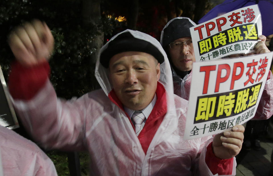 A protester shouts slogans during a rally against the Trans-Pacific Partnership (TPP) in Tokyo, Tuesday, April 22, 2014. In Japan and elsewhere, there are concerns over making politically difficult market-opening concessions without reassurance that Obama will have the "fast track" authority to get congressional approval for TPP. Critics of the plan have balked at granting such power for a trade deal whose contents have been kept largely secret as a precondition for joining. The placards read: "Withdraw TPP negotiation immediately."(AP Photo/Shizuo Kambayashi)