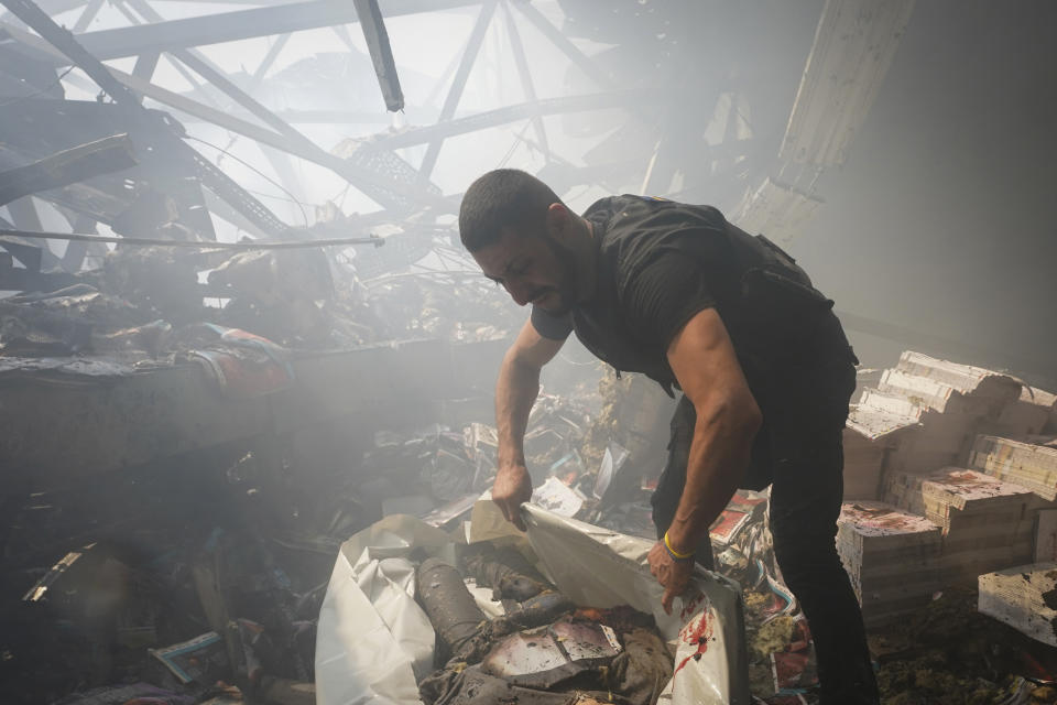 A rescuer recovers a lifeless body from under the rubble after a Russian missile hit a large printing house in Kharkiv, Ukraine, Thursday, May 23, 2024. Russian missiles slammed into Ukraine’s second-largest city in the northeast of the country and killed at least seven civilians early Thursday, officials said, as Kyiv’s army labored to hold off an intense cross-border offensive by the Kremlin’s larger and better-equipped forces. (AP Photo/Andrii Marienko)
