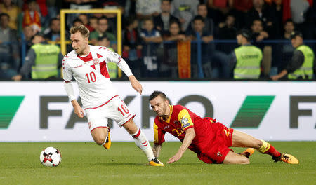 Soccer Football - 2018 World Cup Qualifications - Europe - Montenegro vs Denmark - Podgorica City Stadium, Podgorica, Montenegro - October 5, 2017 Denmark's Christian Eriksen in action with Montenegro’s Marko Simic REUTERS/Stevo Vasiljevic