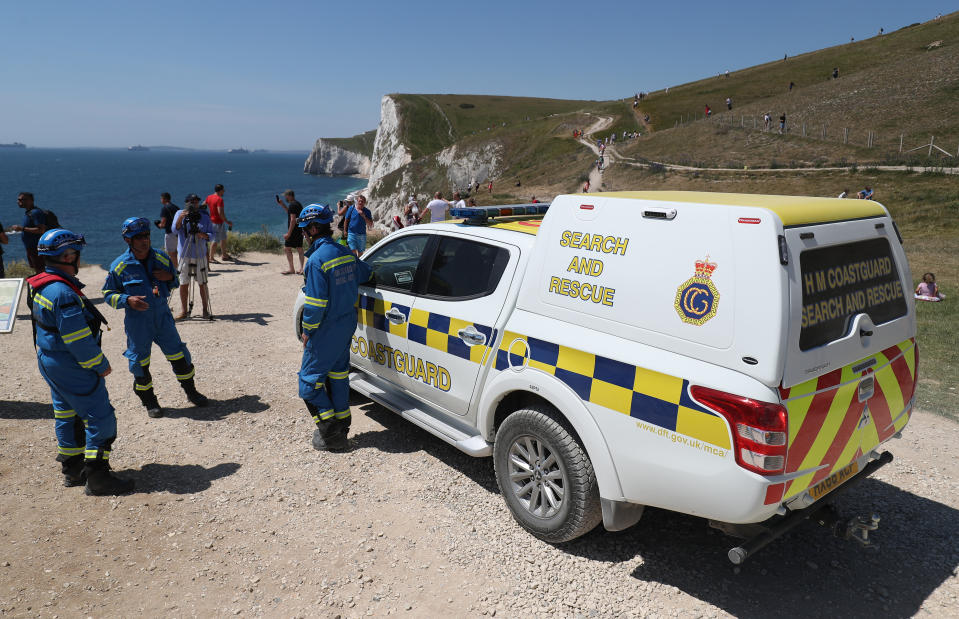 Members of HM Coastguard Search and Rescue at Durdle Door, near Lulworth, despite Dorset Council announcing that the beach was closed to the public after three people were seriously injured jumping off cliffs into the sea.