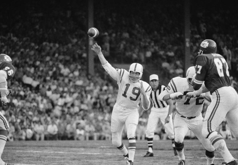 File-This Aug. 15, 1970, file photo shows Baltimore Colts quarterback Johnny Unitas (19) getting off a pass as left tackle Bob Vogel (72) keeps Kansas City's Aaron Brown away in the exhibition game at Kansas City. Members of a special panel of 26 selected all of them for the position as part of the NFL's celebration of its 100th season. All won league titles except Marino. All are in the Hall of Fame except Brady and Manning, who are not yet eligible. On Friday, Dec. 27, 2019, quarterback was the final position revealed for the All-Time Team. (AP Photo/William Straeter, File)