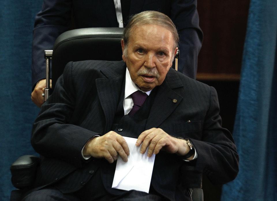 FILE - In this May 4, 2017 file photo, Algerian President Abdelaziz Bouteflika prepares to vote in Algiers. Algeria's powerful army chief said Tuesday March 26, 2019 that he wants to trigger the constitutional process that would declare President Abdelaziz Bouteflika unfit for office, after more than a month of mass protests against the ailing leader's long rule. (AP Photo/Sidali Djarboub, File)