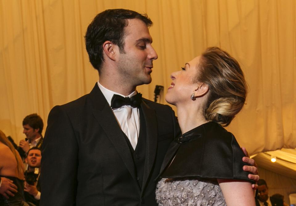 Chelsea Clinton poses with husband Marc Mezvinsky at the Metropolitan Museum of Art Costume Institute Benefit celebrating the opening of "PUNK: Chaos to Couture" in New York, in this May 6, 2013 file photo. Clinton announced April 17, 2014 she is pregnant with the first grandchild of former President Bill Clinton and former Secretary of State Hillary Clinton. REUTERS/Lucas Jackson/files (UNITED STATES - Tags: ENTERTAINMENT FASHION POLITICS)