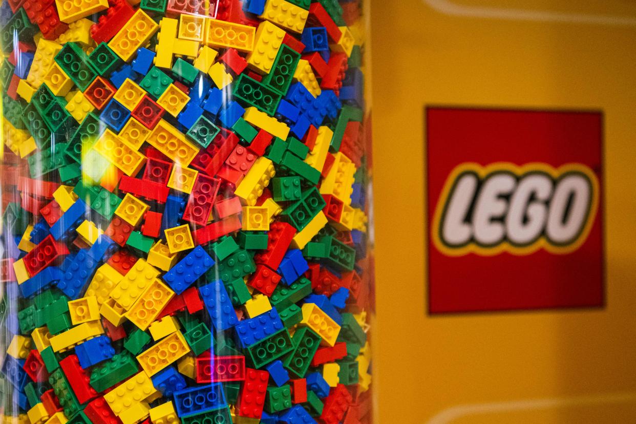  LEGO bricks in clear container with LEGO logo to the side. 