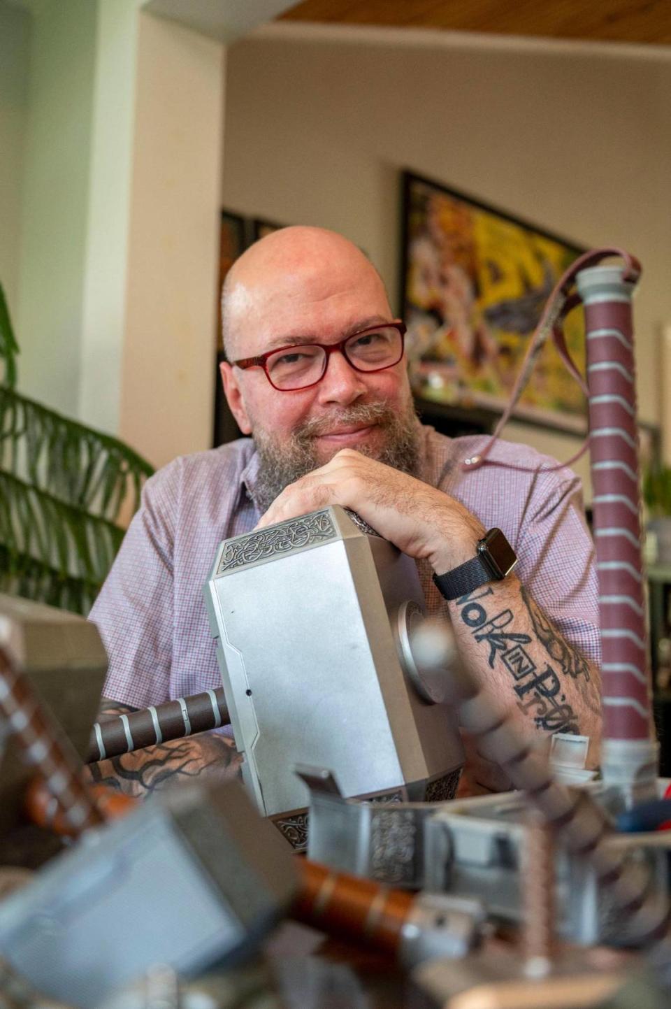 Jason Aaron showcases a variety of Thor hammers at his home in Prairie Village. He’s a key player in the Marvel Comics universe, creating the plotlines for the upcoming movie “Thor: Love and Thunder.”