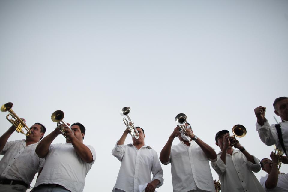 A brass band plays songs known to be favorites of Joaquin "Chapo" Guzman during a march in Culiacan